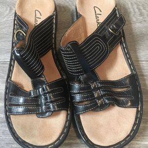 Clark’s black leather sandals.